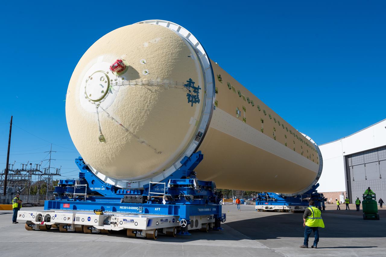 Technicians transported the assembled upper part of the Artemis II core stage to the final assembly area inside the factory at NASA’s Michoud Assembly Facility in New Orleans.  On Jan 10, the forward assembly, left was moved next to the Artemis II liquid hydrogen tank, which has been undergoing assembly. Next, Boeing, the lead core stage contractor, will join the forward assembly and the liquid hydrogen tank to complete most of the core stage for the Space Launch System (SLS) rocket that will send the first crew on an Artemis mission. The core stage consists of five major structures that are built, outfitted, and then connected to form the final stage. The forward skirt, liquid oxygen and intertank were connected and tested to form the 66-foot forward assembly. After the forward assembly is joined with the 130-foot liquid hydrogen tank, only the engine section, the fifth piece of the stage, will need to be added to complete the Artemis II core stage.  The core stage serves as the backbone of the rocket, supporting the weight of the payload, upper stage, and crew vehicle, as well as the thrust of its four RS-25 engines and two five-segment solid rocket boosters attached to the engine and intertank sections. On Artemis II, the SLS rocket will launch the Orion spacecraft and a crew, sending them into lunar orbit, in preparation for later Artemis missions that will enable the first woman and first person of color to land on the Moon.